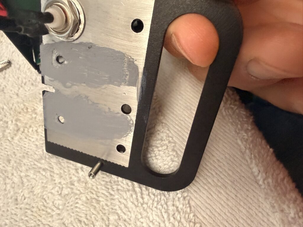Inside of the KX2 side rail showing the internally threaded standoff protruding through the plate